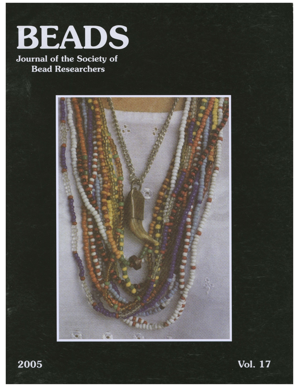 Volume 17 cover, a close up on a person wearing 10-20 beaded necklaces.